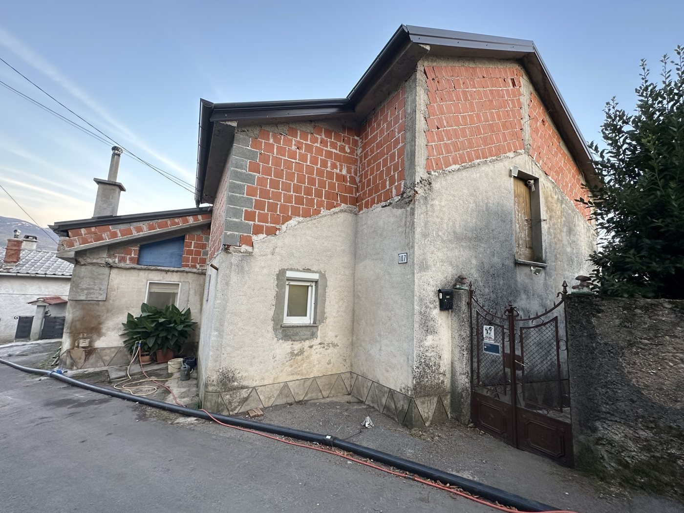 A two-story stone house on a village street in Podkilavac, Croatia